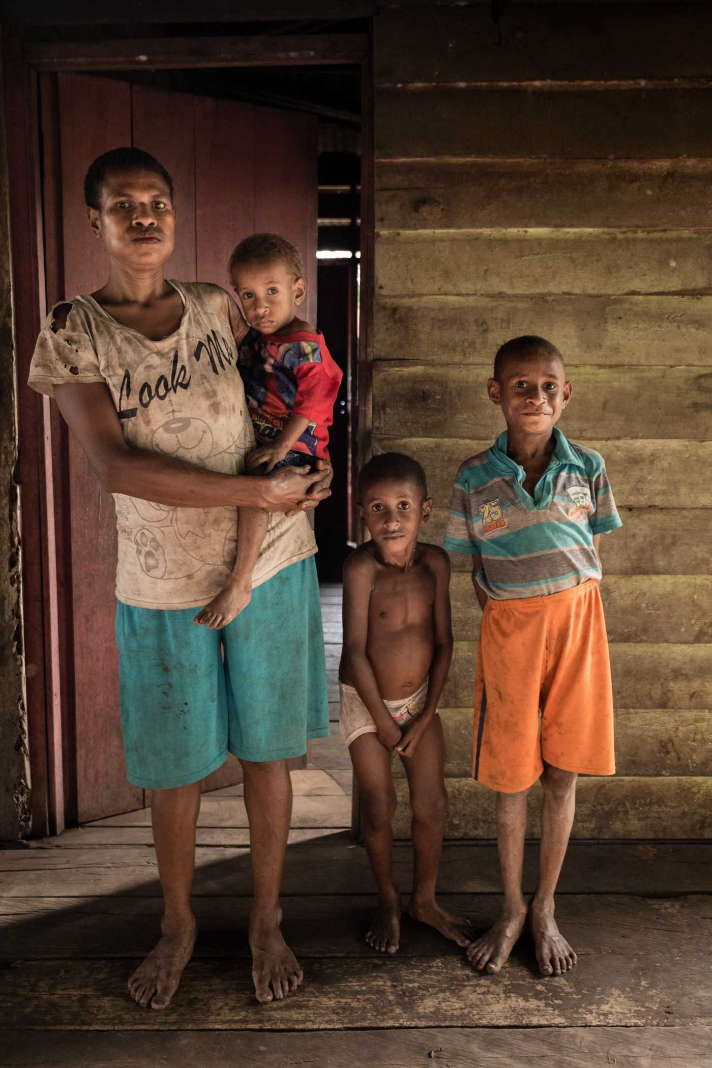 Friska Basik-basik, 26, with her sons.